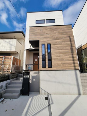 シンプルでスタイリッシュな外観が特徴です。木目調パネルがアクセントとなり洗練された印象を与えます。縦長の窓が外観にすっきりとした雰囲気をプラスしています。モダンなデザインで周囲と調和した一棟です。