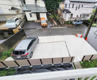 現地からの眺望は周辺の住宅街や道路が見渡せます。駐車スペースも視界に入り全体的に落ち着いた印象です。車の出し入れがしやすそうな配置で日常の様子が一目でわかります。道路との距離感もつかみやすい眺望です。