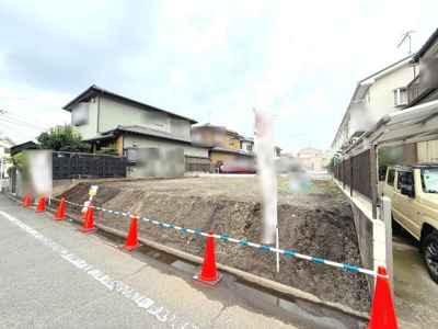 ゆとりあるスペースが広がる土地写真です。道路に面しているためアクセスしやすく日当たりも期待できます。周辺には住宅が建ち並び落ち着いた環境が感じられます。造成済みのきれいな土地です。