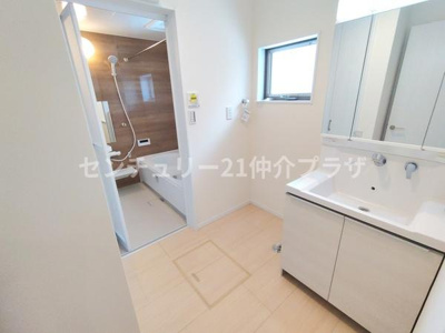 清潔感のある洗面台と明るい空間が特長です。窓があることで換気もしやすく使い勝手の良いレイアウトとなっています。バスルームへの動線もスムーズで日々の暮らしに便利な洗面所です。