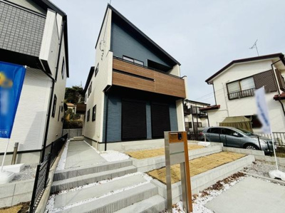 スタイリッシュな外観が目を引く住宅です。広めの玄関アプローチとゆとりある敷地が魅力です。2階部分のバルコニーがアクセントになっています。シンプルなデザインで落ち着いた印象です。