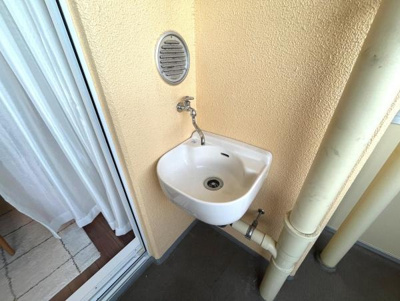 バルコニーに便利な水栓付きの洗面が設置されています。ちょっとした作業や手洗いに役立ちます。スペースが有効に活用できる設計です。設備の管理がしやすい配置です。暮らしの幅が広がる仕様となっています。