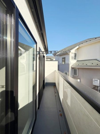 バルコニーは手すりが設けられておりしっかりとした造りです。ガラス戸からの採光があり室内への光の取り入れにも貢献します。空が広がる開放感のある空間です。建物同士の距離感を感じることができます。